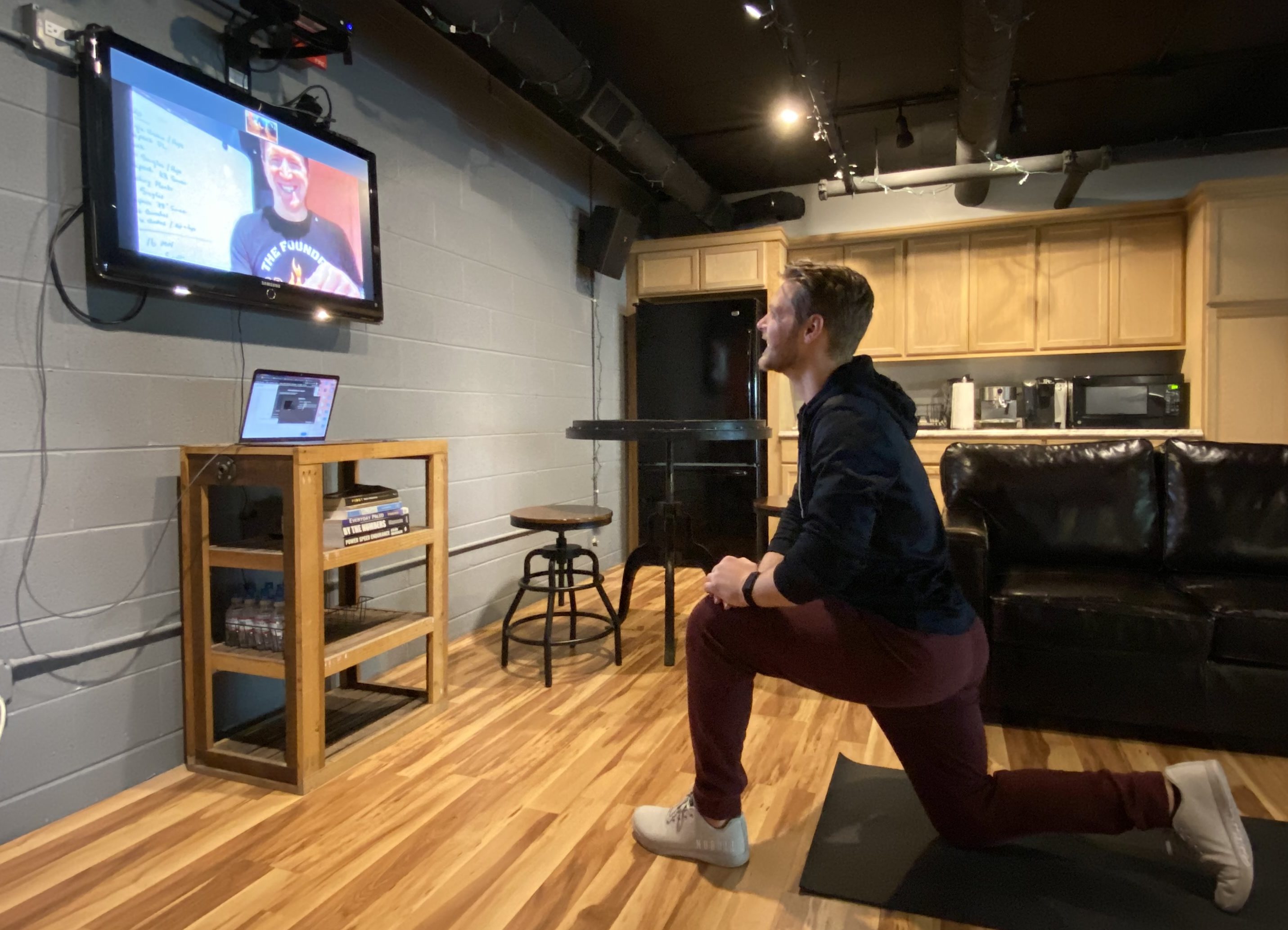 Image of a man doing an online group fitness class working out from home